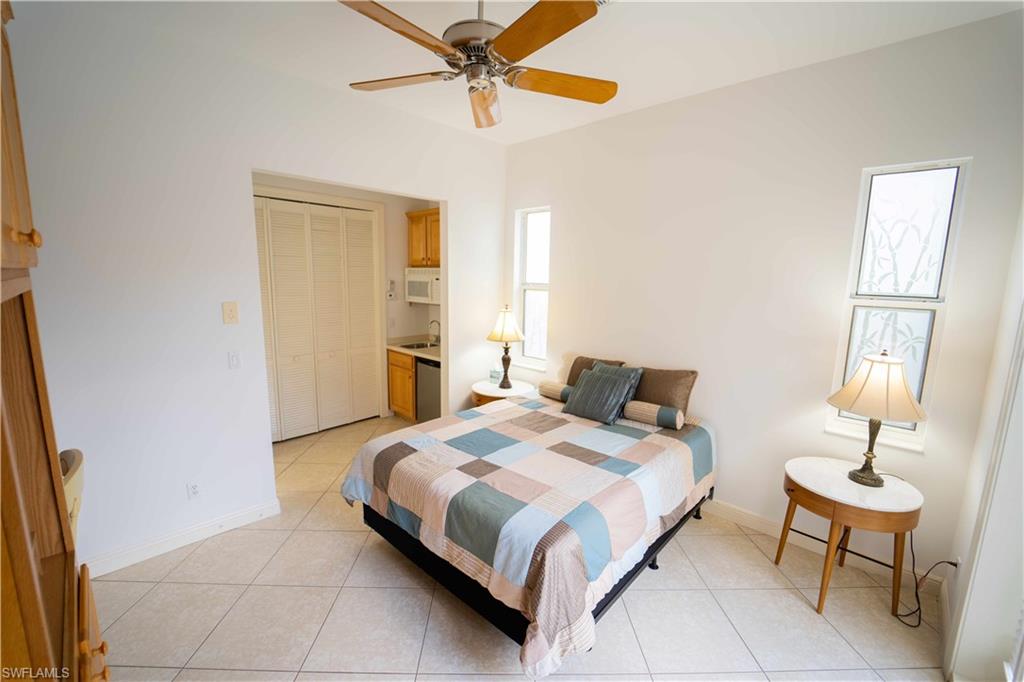 5886 Paradise Circle Naples, FL 34110 - Photo 13 of 19 Tiled bedroom with ceiling fan and sink