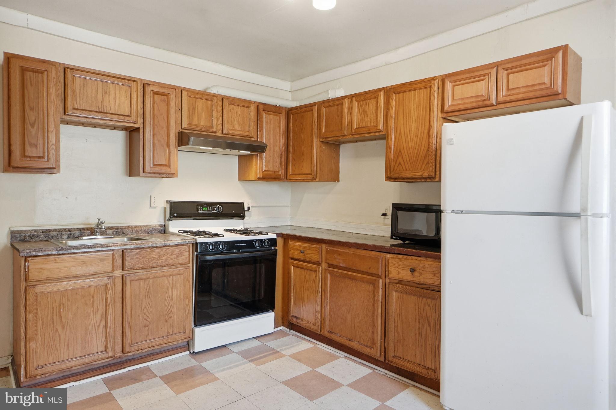 3449 Old Frederick Road Baltimore, MD 21229 - Photo 7 of 25 Cozy kitchen with classic wood cabinetry.