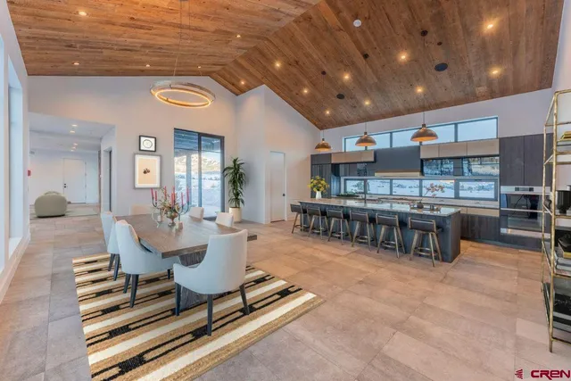 a living room with lots of furniture and kitchen view