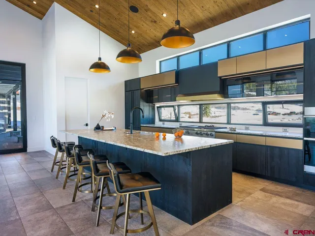 a kitchen with stainless steel appliances granite countertop a sink and cabinets