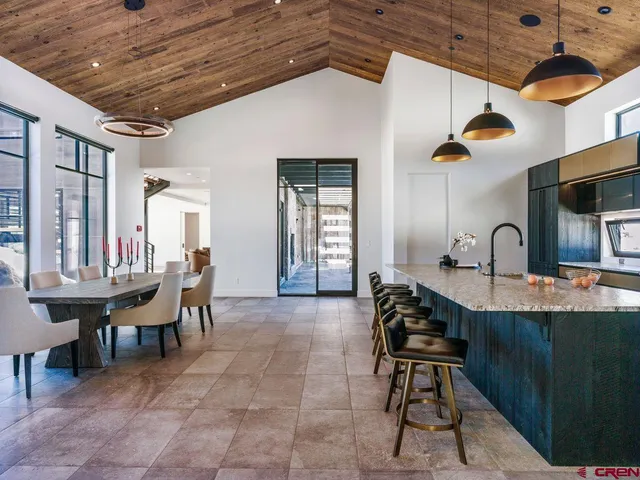 a dining room with furniture and chandelier