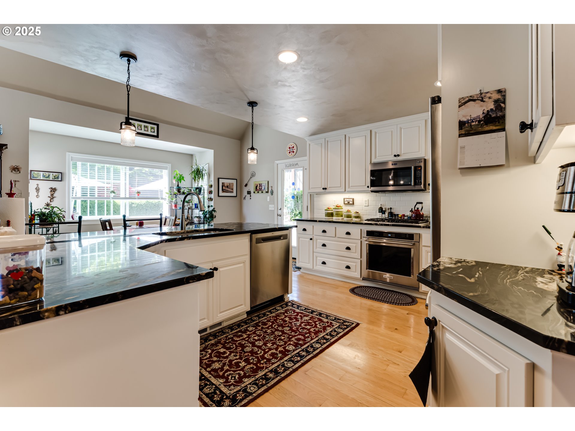 6111 Fernhill Loop Springfield, OR 97478 - Photo 18 of 48 a kitchen with stainless steel appliances kitchen island granite countertop a sink stove and refrigerator