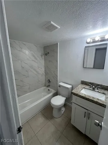 a bathroom with a sink a toilet and bathtub