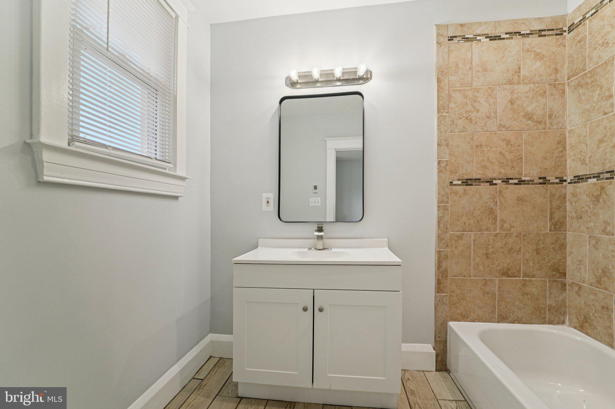3030 Dunleer Road Dundalk, MD 21222 - Photo 12 of 26 a bathroom with a sink a toilet and shower