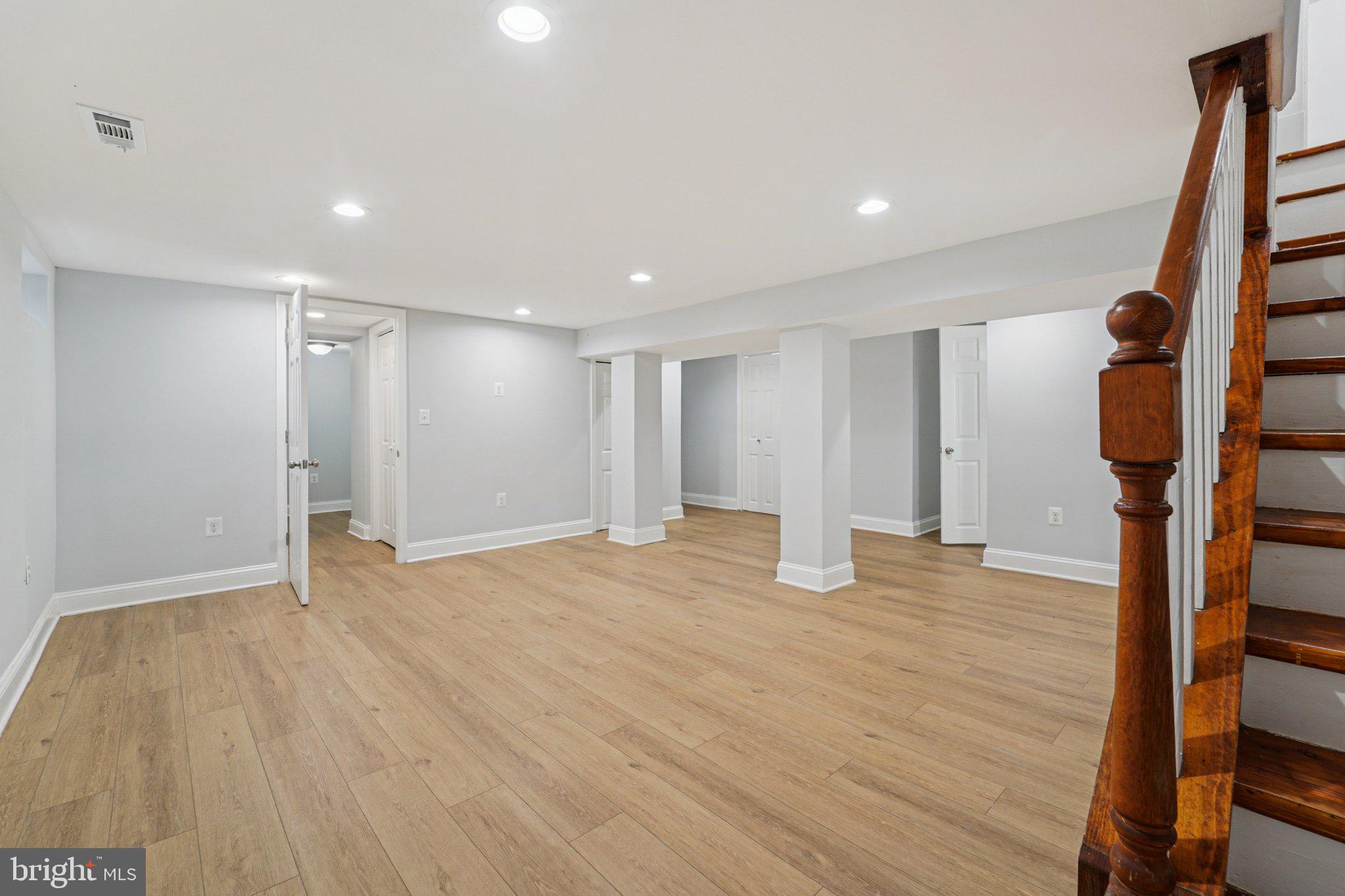 3030 Dunleer Road Dundalk, MD 21222 - Photo 13 of 26 a view of an empty room with wooden floor and stairs