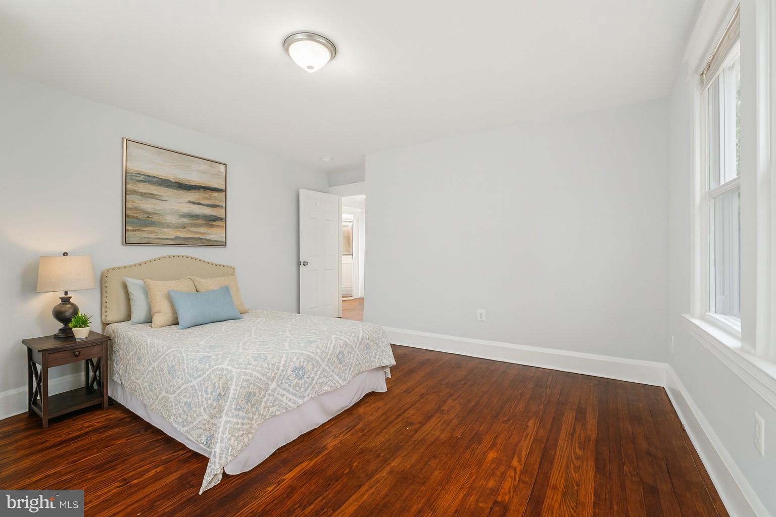 3030 Dunleer Road Dundalk, MD 21222 - Photo 17 of 26 a bedroom with a bed and wooden floor