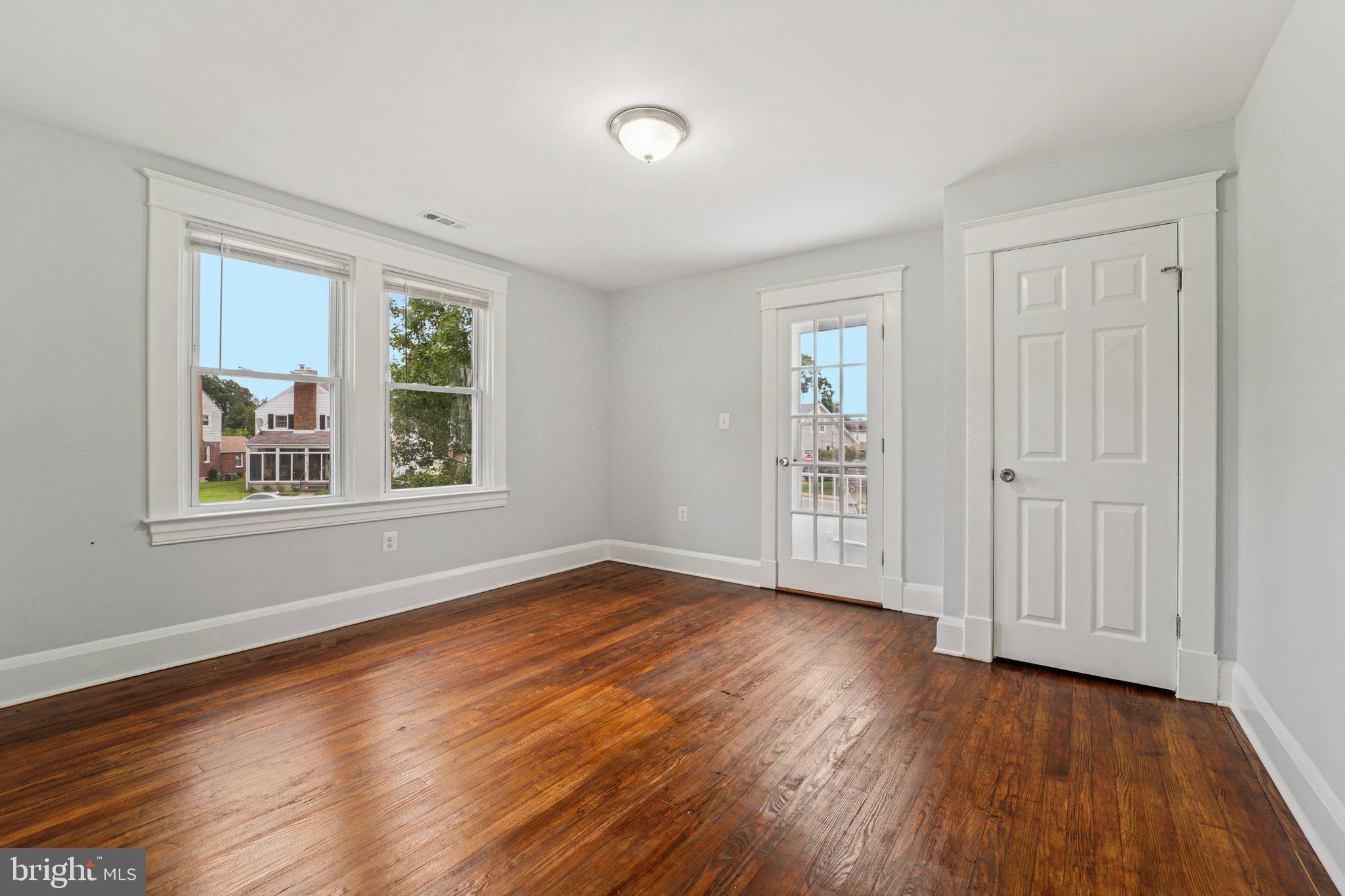 3030 Dunleer Road Dundalk, MD 21222 - Photo 19 of 26 a view of an empty room with wooden floor and a window