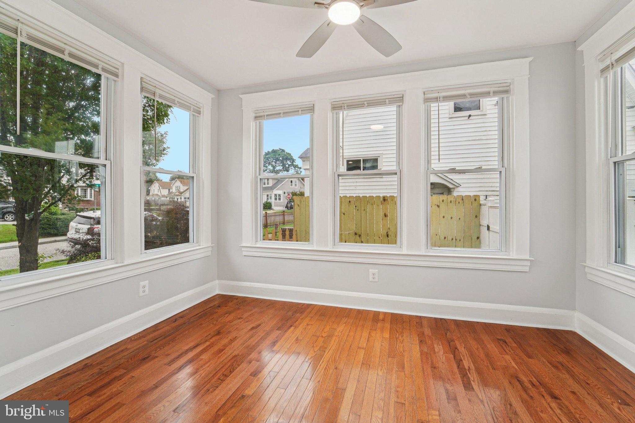 3030 Dunleer Road Dundalk, MD 21222 - Photo 6 of 26 a view of an empty room with wooden floor and a window