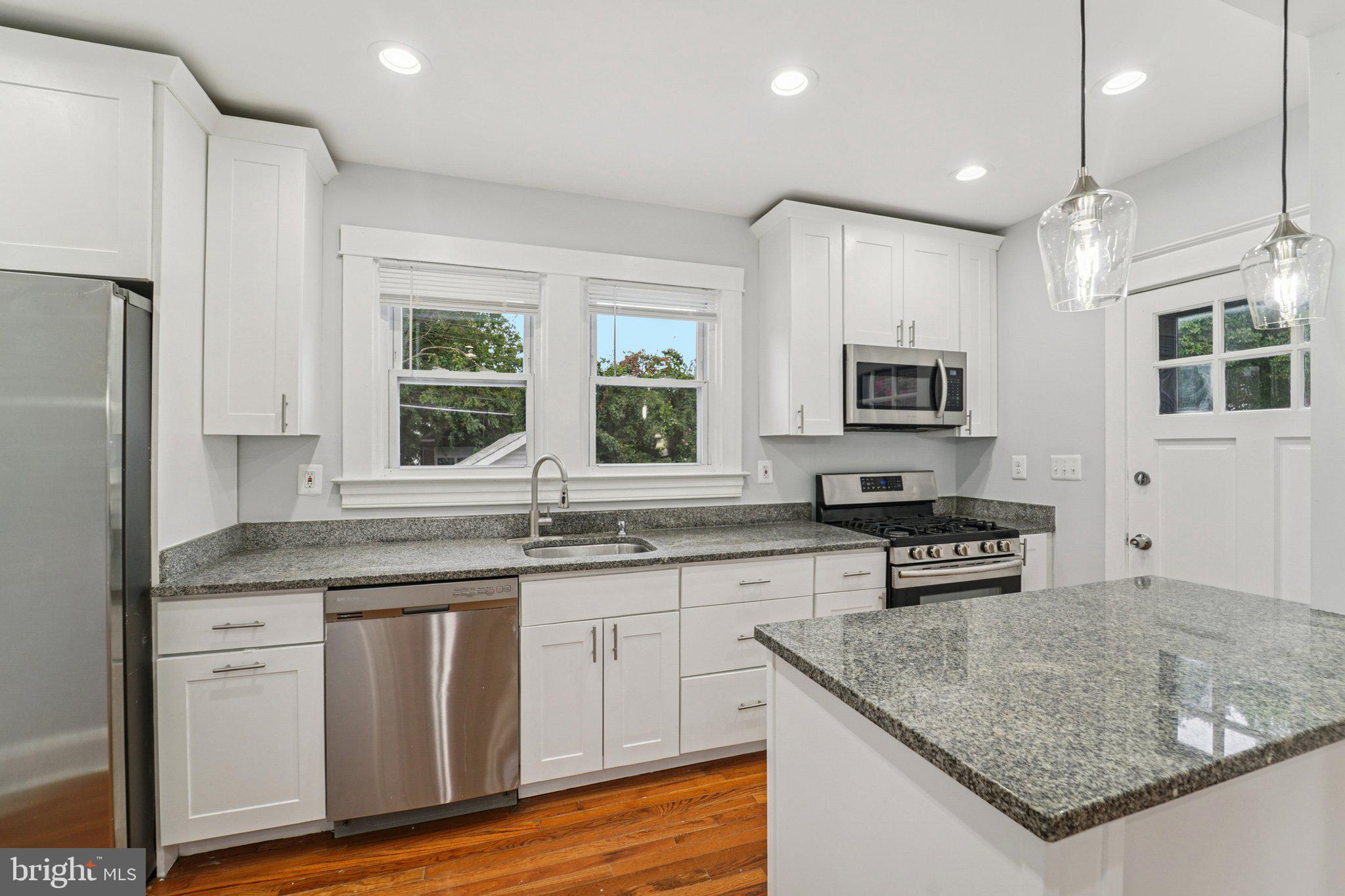 3030 Dunleer Road Dundalk, MD 21222 - Photo 10 of 26 a kitchen with stainless steel appliances granite countertop a sink stove and refrigerator