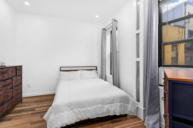 a bedroom with a bed and flat screen tv