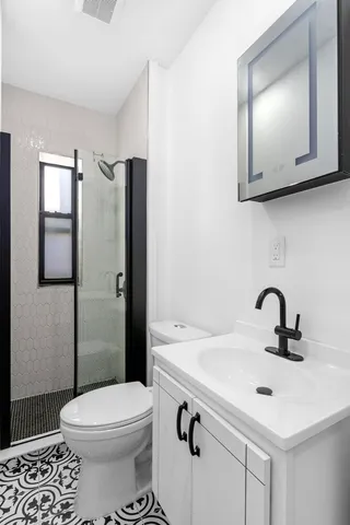 a bedroom with a bed and a television