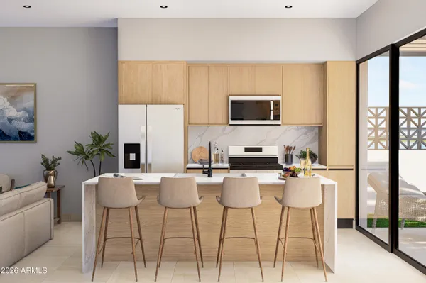 a kitchen with a stove a sink a microwave a dining table and chairs