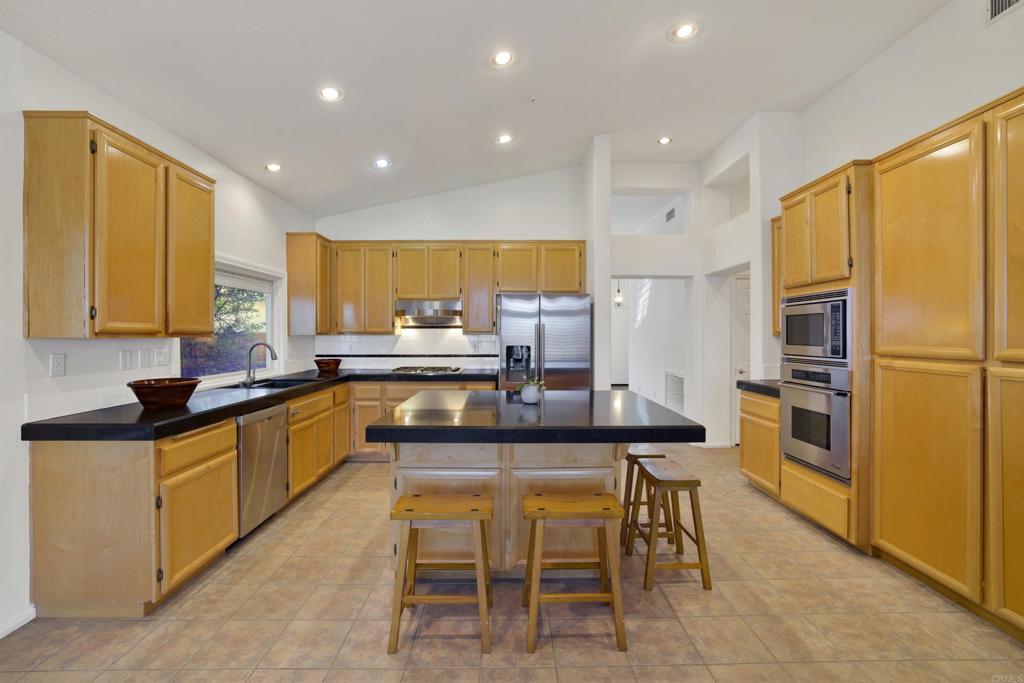 2022 Highland View Escondido, CA 92026 - Photo 11 of 47 a kitchen with stainless steel appliances granite countertop table chairs sink and cabinets