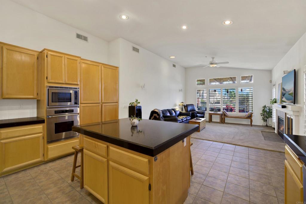 2022 Highland View Escondido, CA 92026 - Photo 13 of 47 a kitchen with kitchen island granite countertop a stove refrigerator and cabinets