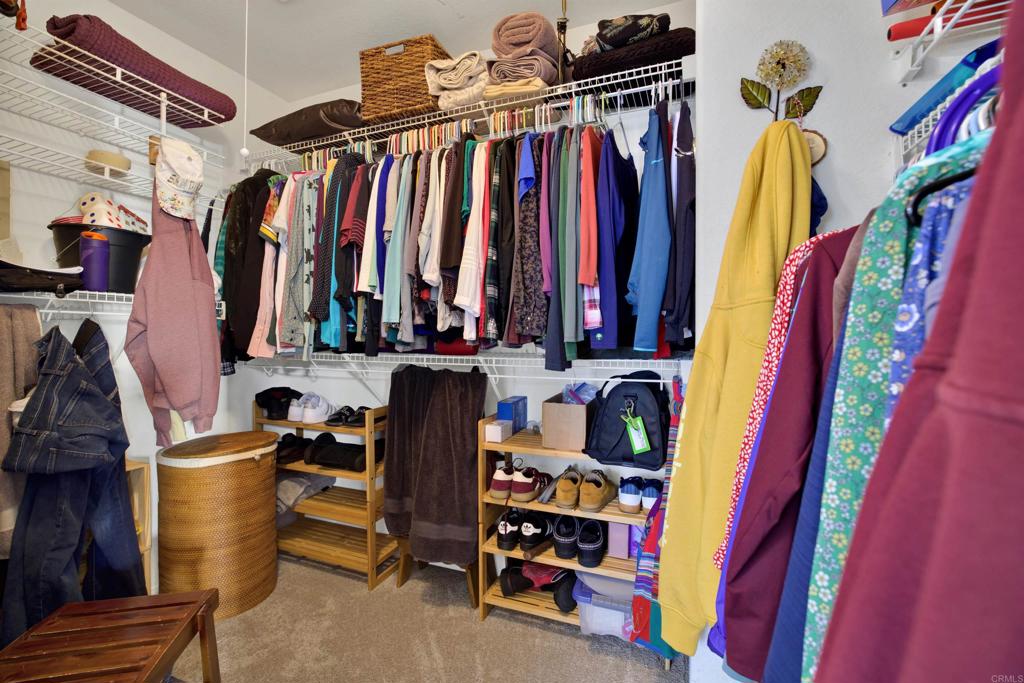 2022 Highland View Escondido, CA 92026 - Photo 22 of 47 a view of walk in closet with clothes and shoes