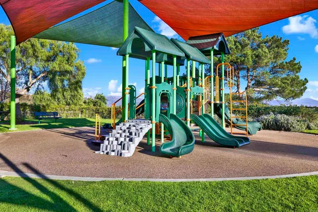 an aerial view of a house with a yard and outdoor seating