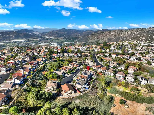 an aerial view of residential houses with outdoor and green space