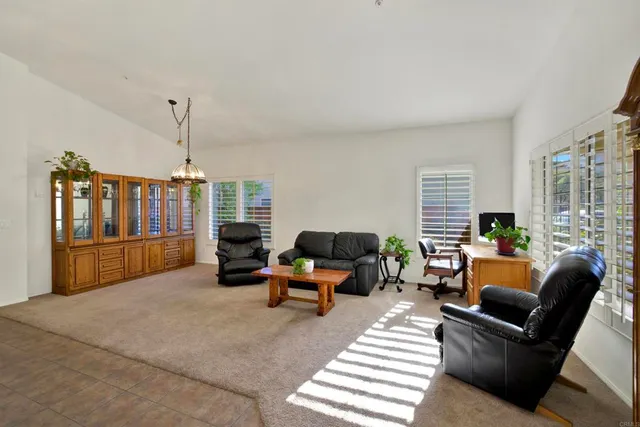 a living room with furniture large window and flat screen tv