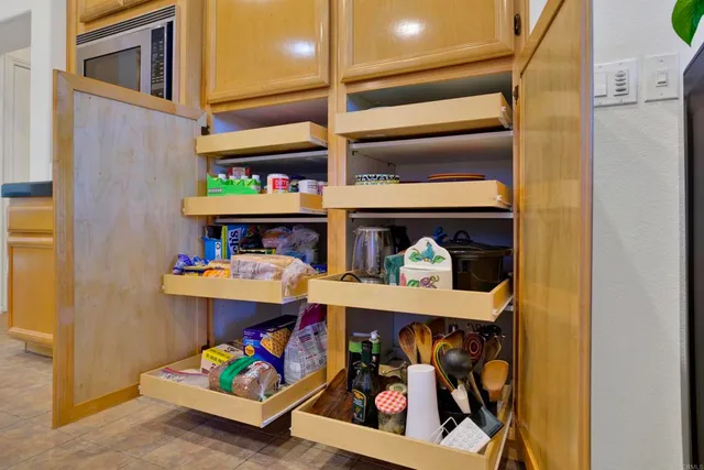 a kitchen with stainless steel appliances granite countertop table chairs sink and cabinets