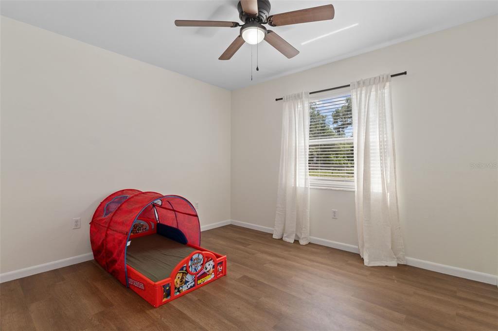 4325 South Canton Terrace Inverness, FL 34452 - Photo 11 of 35 an empty room with wooden floor and windows