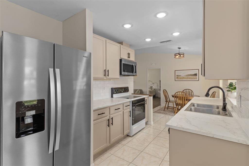 4325 South Canton Terrace Inverness, FL 34452 - Photo 33 of 35 a kitchen with stainless steel appliances granite countertop a refrigerator sink and stove