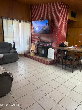 a living room with furniture a window and a flat screen tv