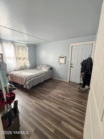 a bedroom with double bed and a window