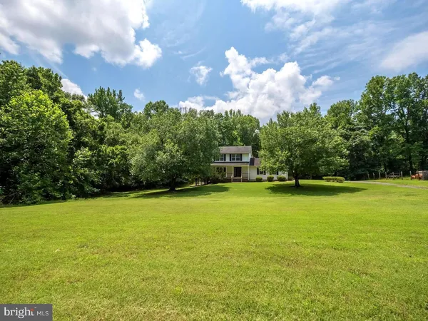 a view of a big yard with swimming pool and green space