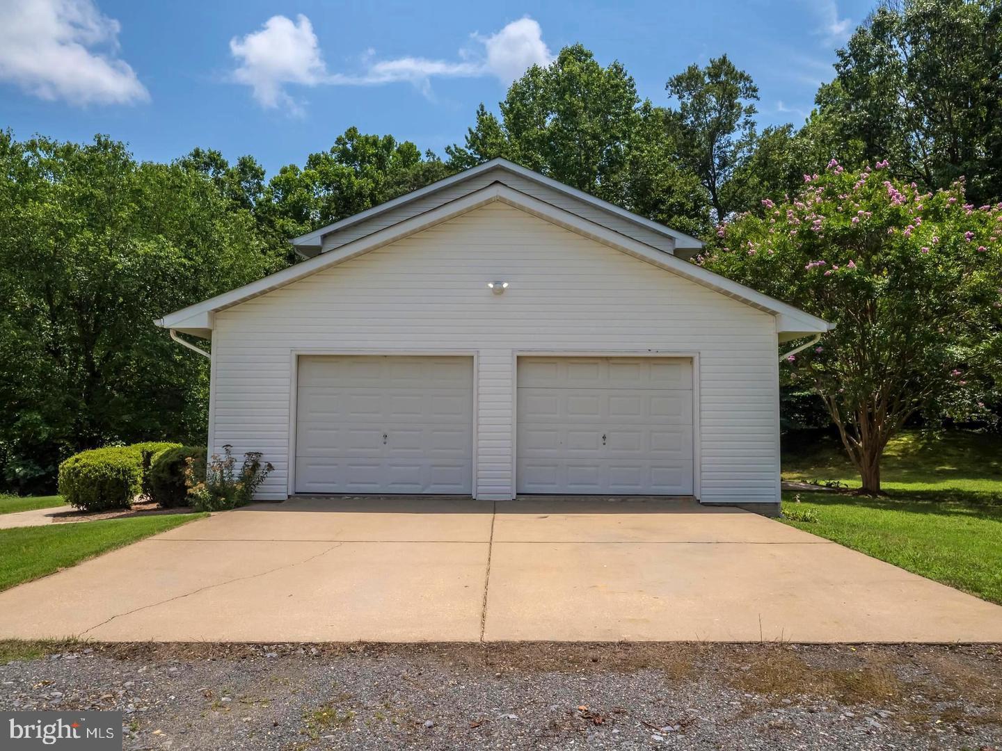 7701 Croom Road Upper Marlboro, MD 20772 - Photo 10 of 53 Charming garage nestled in lush greenery.