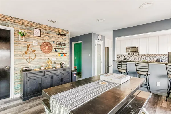 a bedroom with a bed and dresser with mirror
