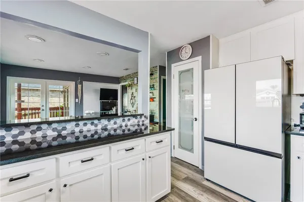 a kitchen with stainless steel appliances a refrigerator and cabinets