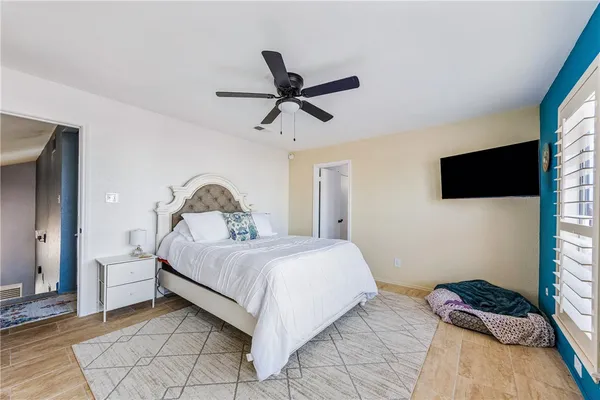 a bedroom with a bed and a flat screen tv