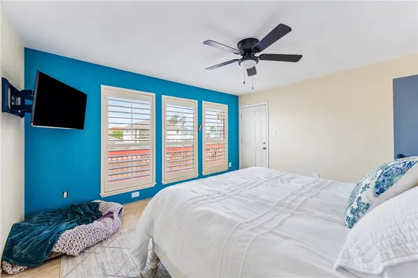 a bedroom with a large bed and a flat screen tv