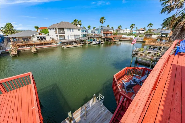 a view of a lake with couches chairs and a table