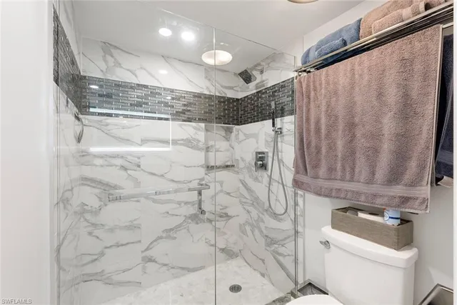 a bedroom with double bed and a large window