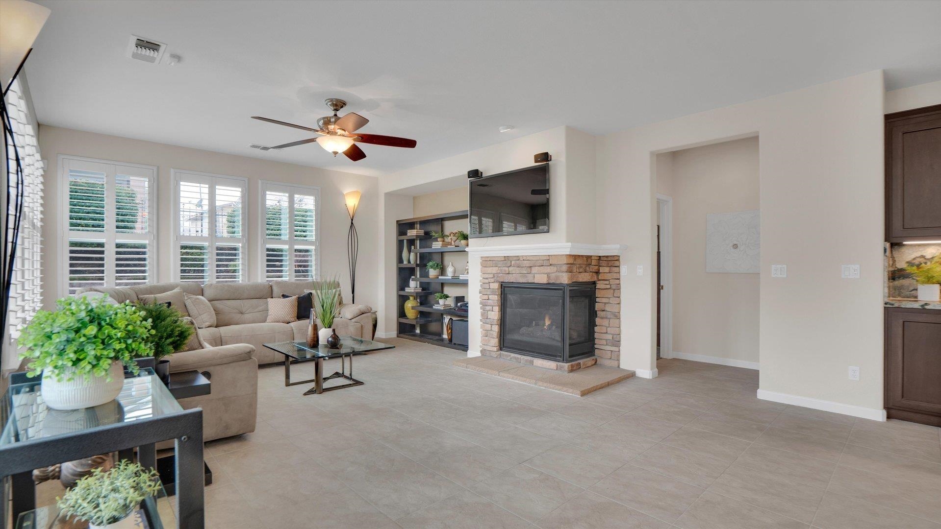 499 Twin Lakes Lane Rio Vista, CA 94571 - Photo 16 of 32 a living room with furniture a fireplace and a flat screen tv