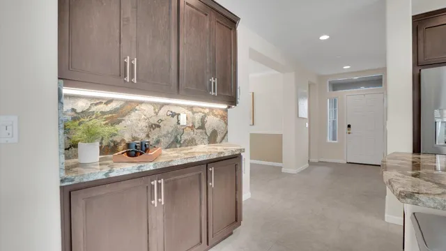 a view of a dining room with furniture and chandelier