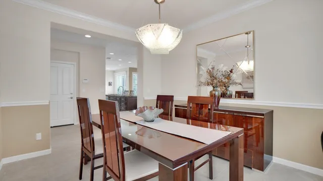 a living room with furniture and large windows
