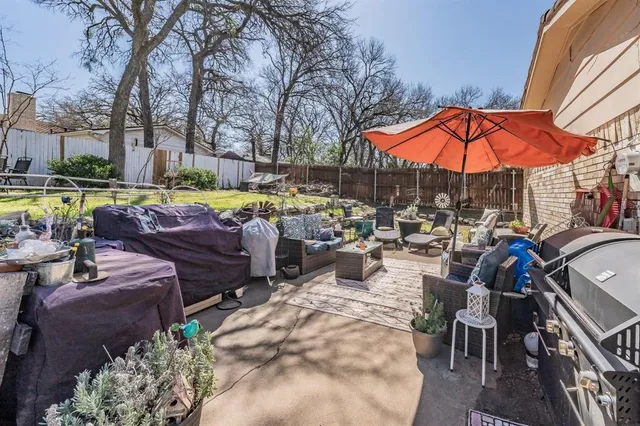 a view of a backyard with wooden fence