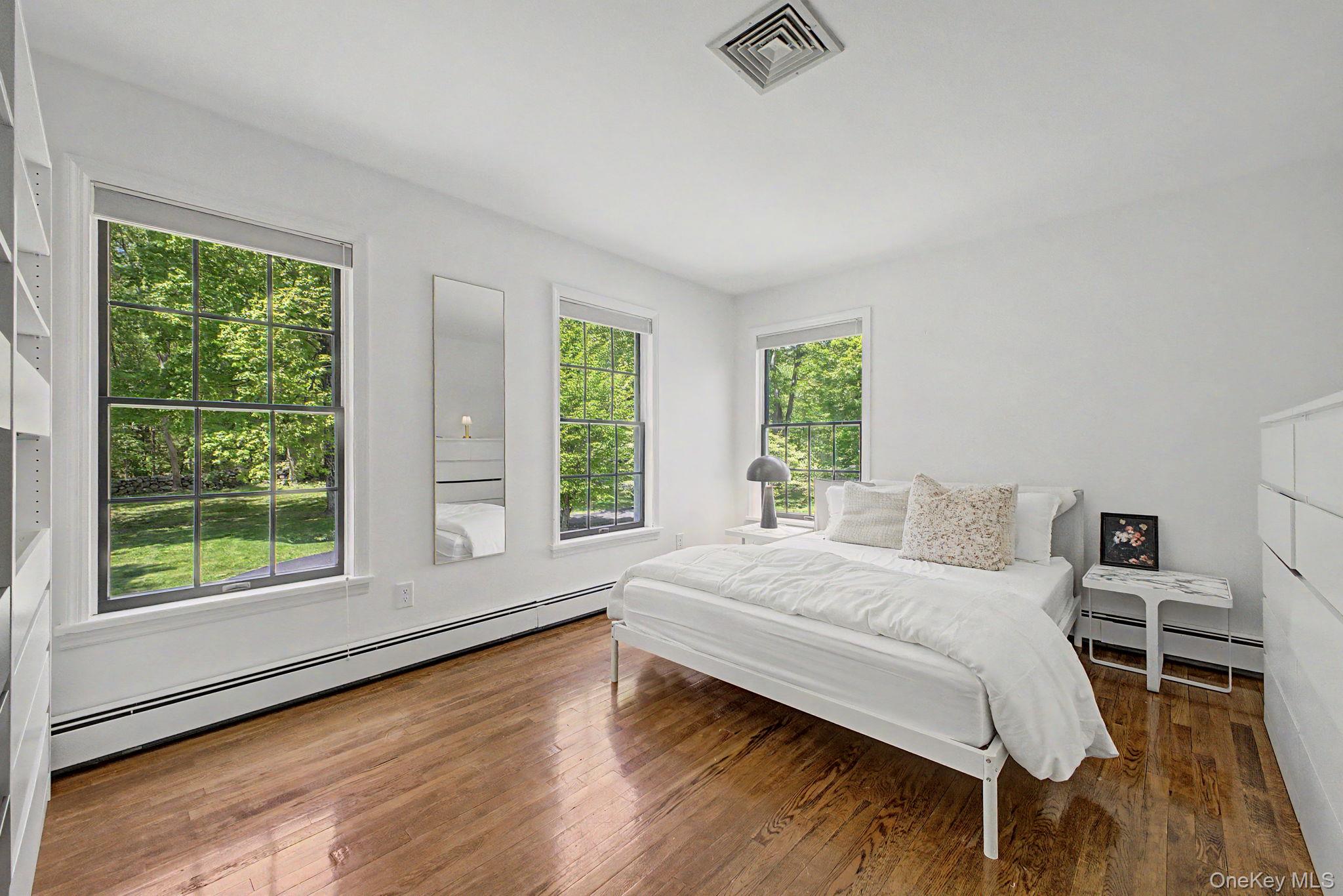 240 Eastwoods Road Pound Ridge, NY 10576 - Photo 34 of 46 a bedroom with a bed and window