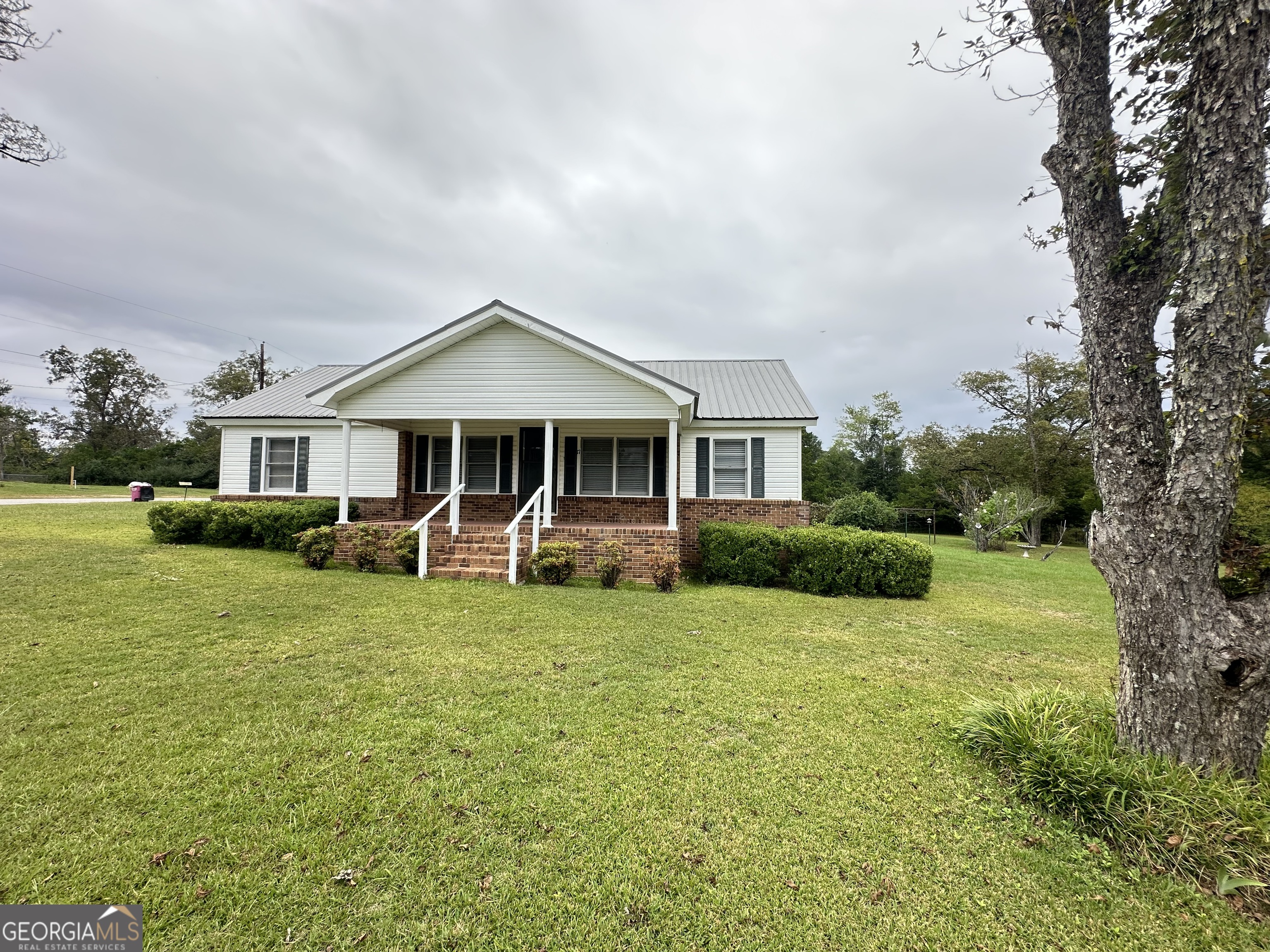 17 2nd Street McRae-Helena, GA 31037 - Photo 1 of 34 a front view of a house with a yard table and chairs