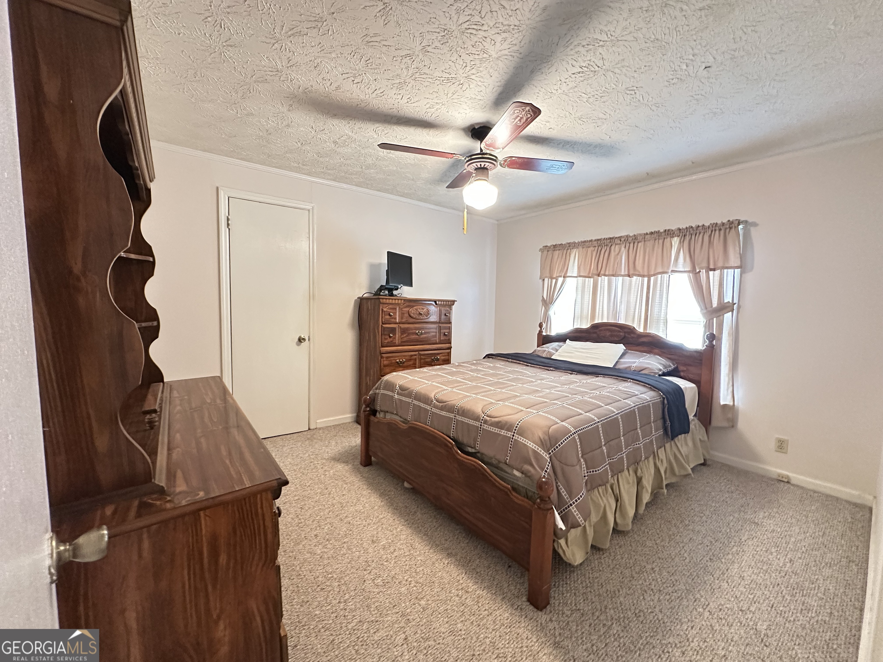 17 2nd Street McRae-Helena, GA 31037 - Photo 21 of 34 a spacious bedroom with a bed and a chandelier