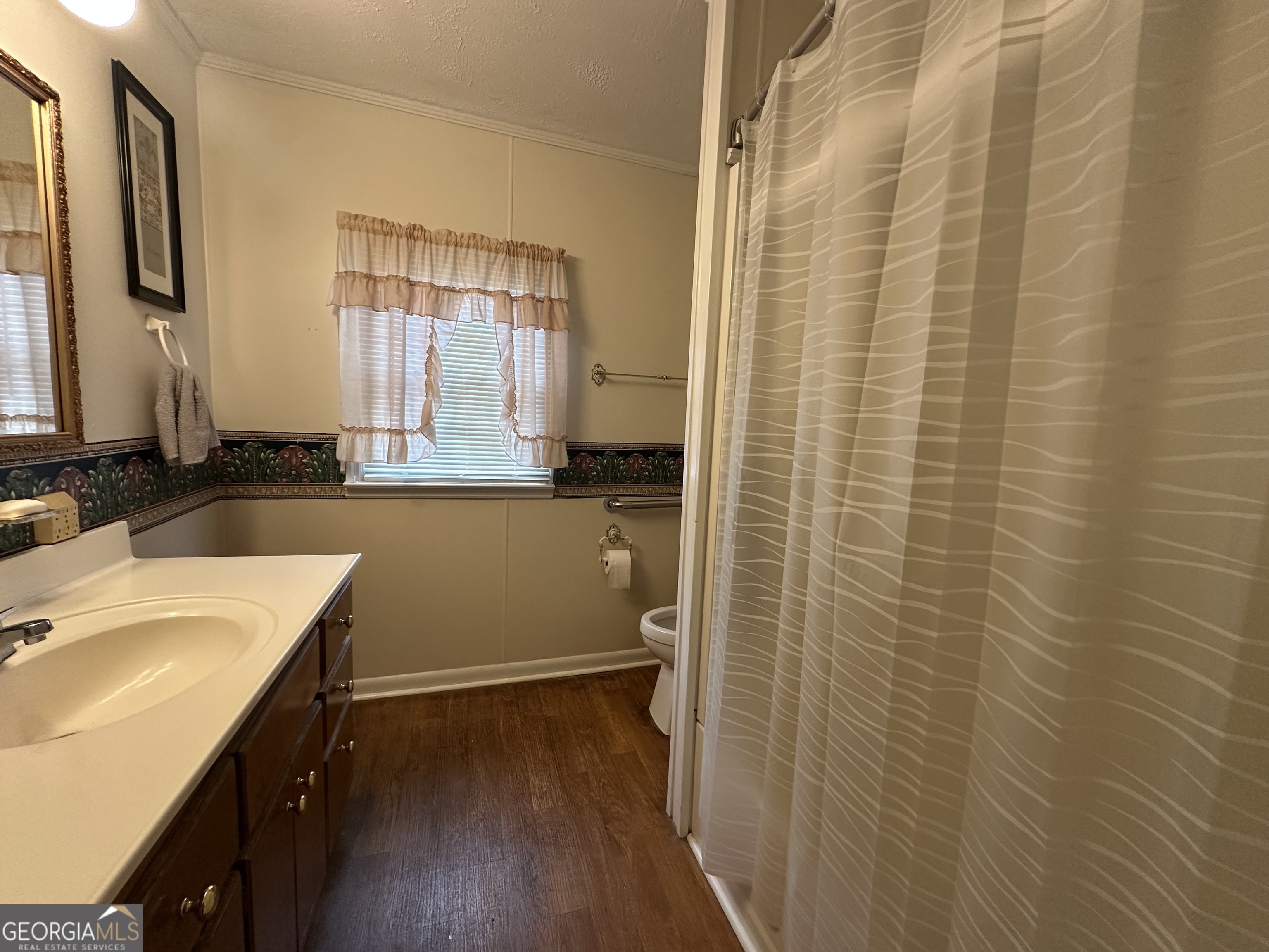 17 2nd Street McRae-Helena, GA 31037 - Photo 22 of 34 a bathroom with a sink a mirror and a shower