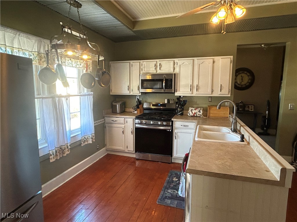 150 West Athens Road Roseville, OH 43777 - Photo 6 of 17 Kitchen with white cabinets, stainless steel appliances, dark wood-style floors, light countertops, and ceiling fan