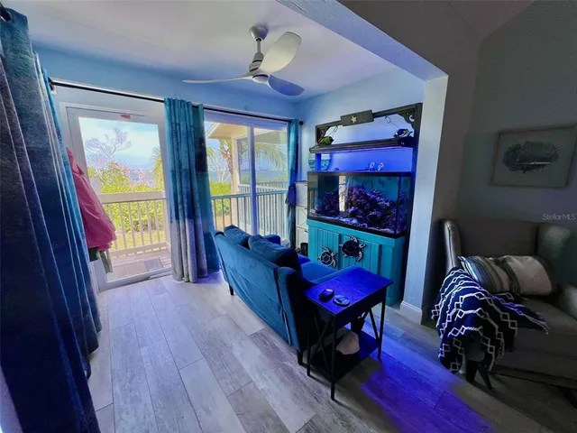 a living room with furniture a bed and a window