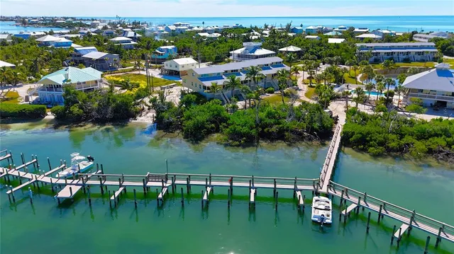 an aerial view of lake residential house with outdoor space and trees around