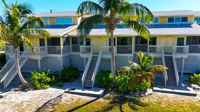 a view of a multi story building with large windows and plants