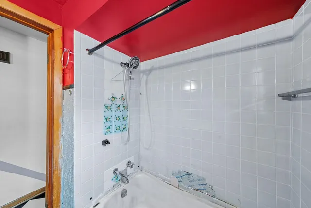 a bathroom with a bathtub and shower