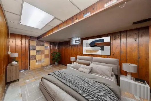 a bedroom with a bed and a large window