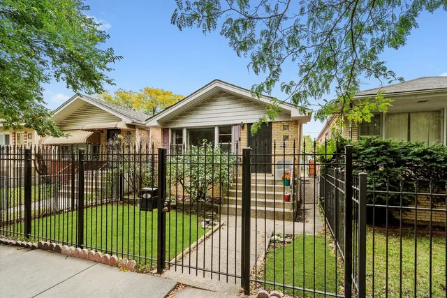a front view of a house with a garden and plants